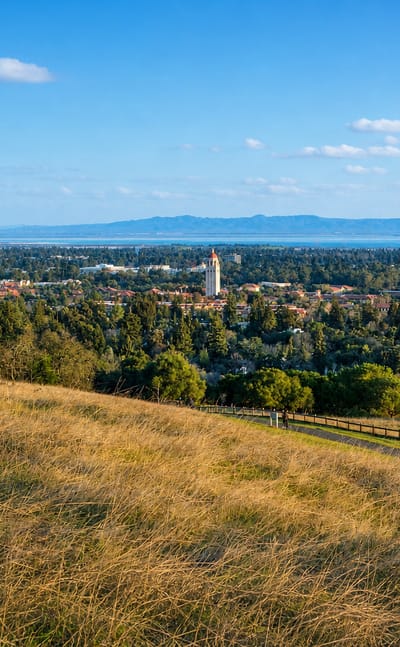 Palo Alto and Stanford's Hoover Tower viewed across golden foothills toward San Francisco Bay