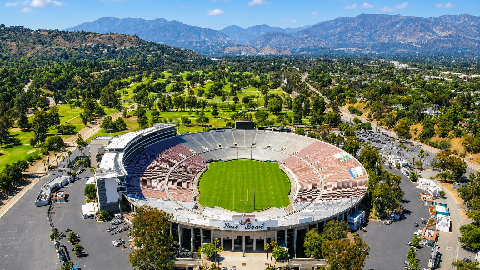 Aerial of Pasadena's Rose Bowl stadium backed by the San Gabriel Mountains