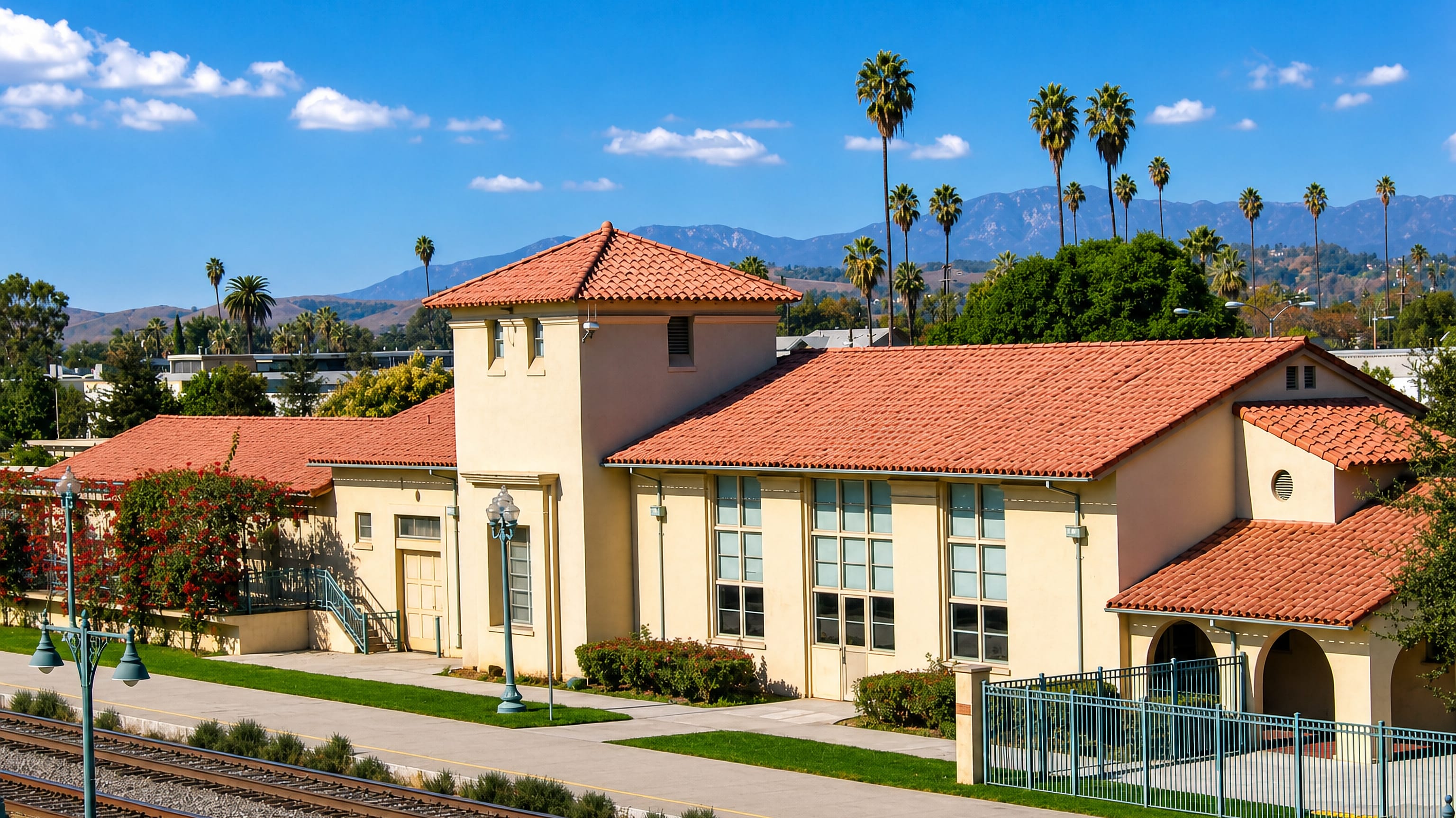 The Spanish Colonial railway depot and palms with the San Gabriel Mountains beyond, Pomona, California.