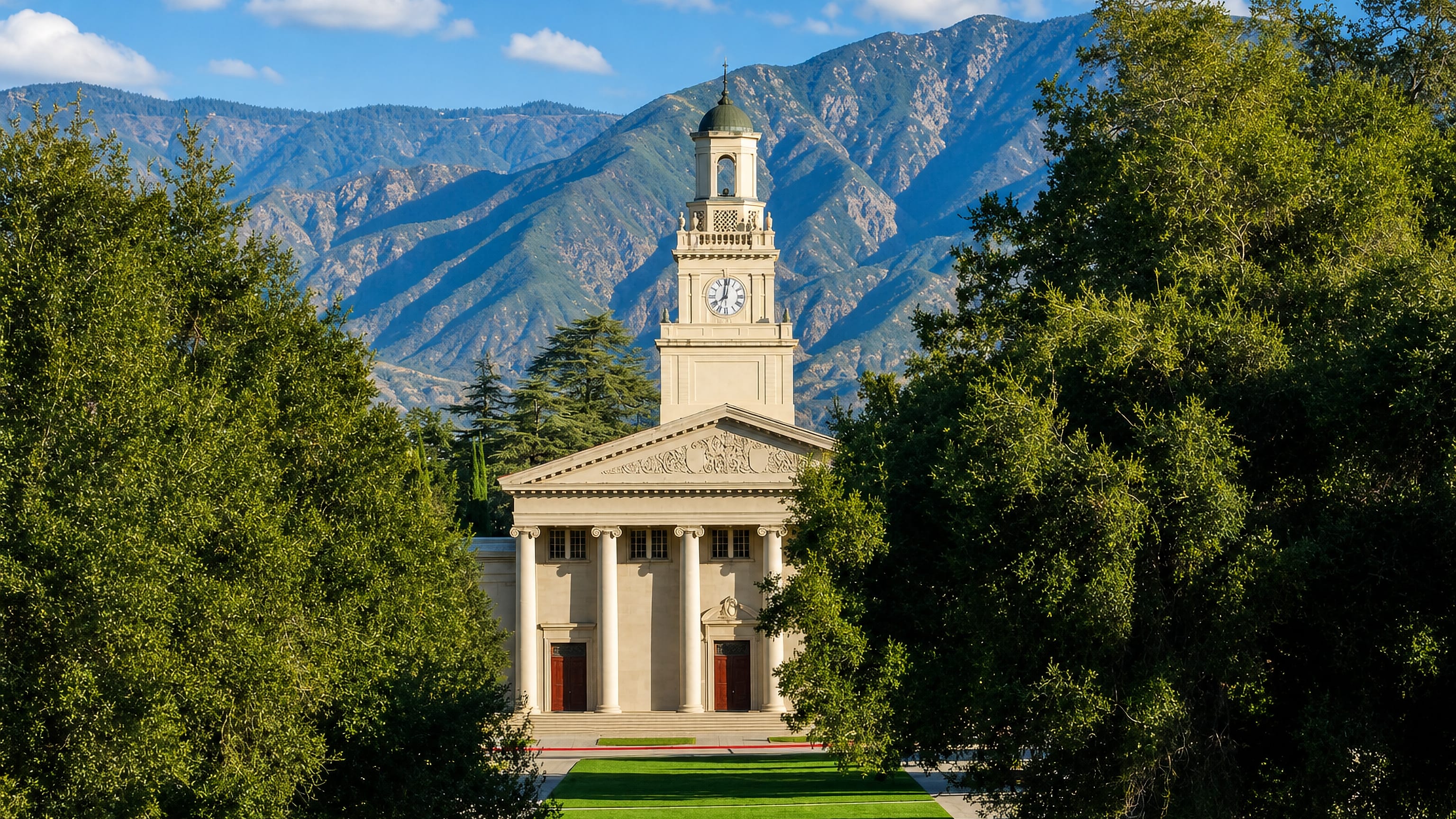 The University of Redlands chapel and clock tower framed by trees below the mountains in Redlands, California.