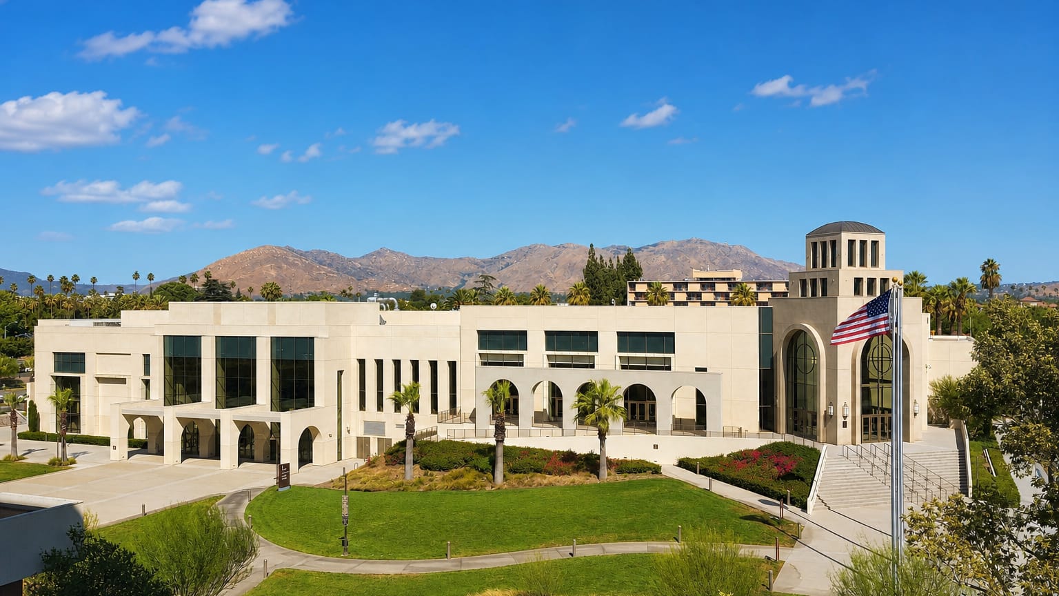 A Mission Revival-style civic building with palms and mountains in Riverside, California