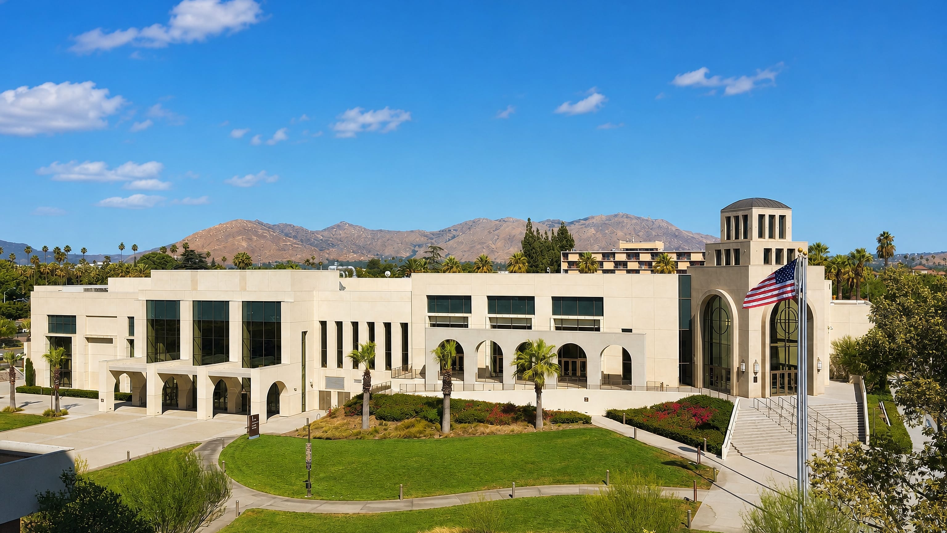 A Mission Revival-style civic building with palms and mountains in Riverside, California