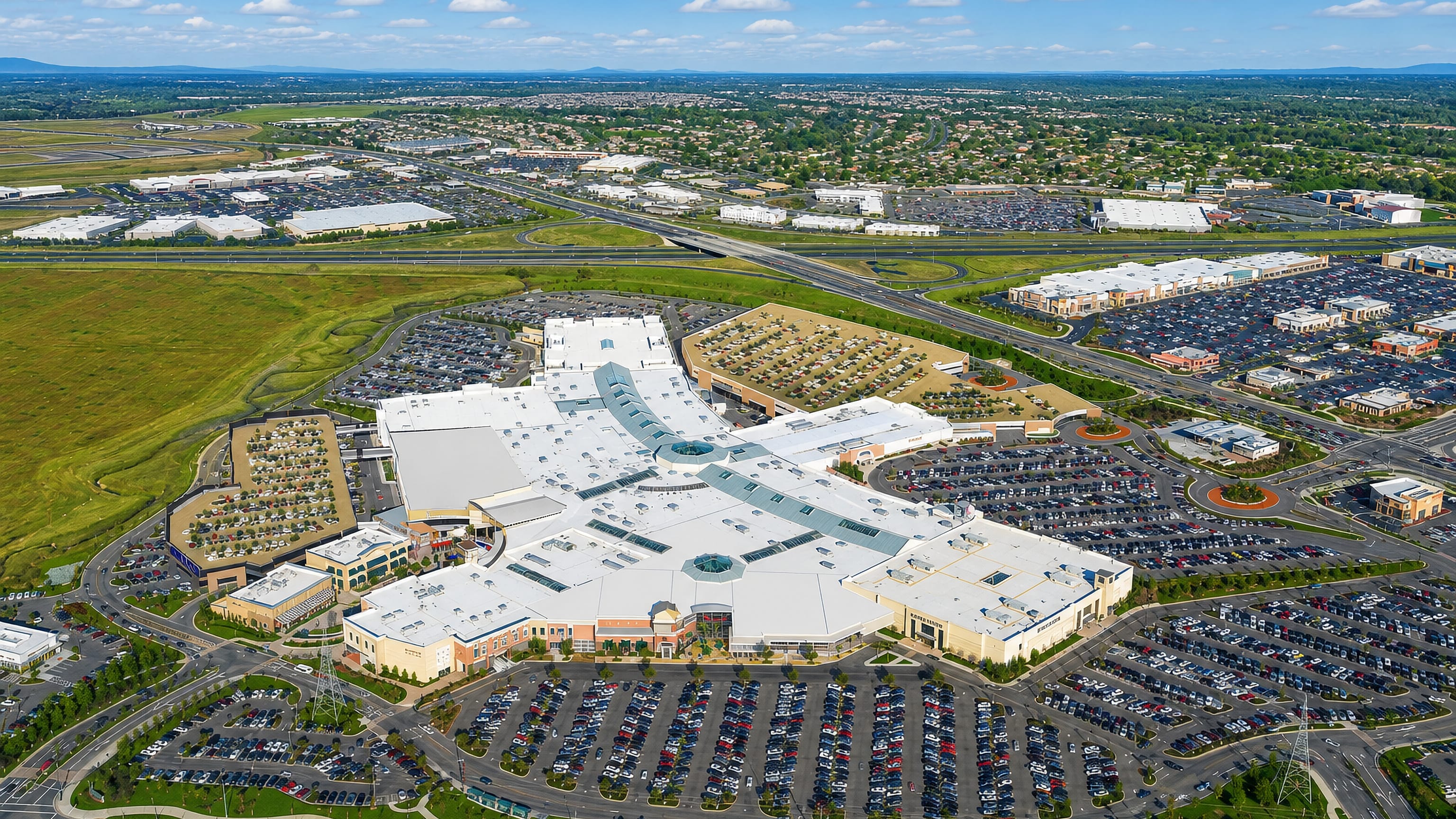 Aerial view of a large shopping mall and its parking lots amid the suburban sprawl of Roseville, California.