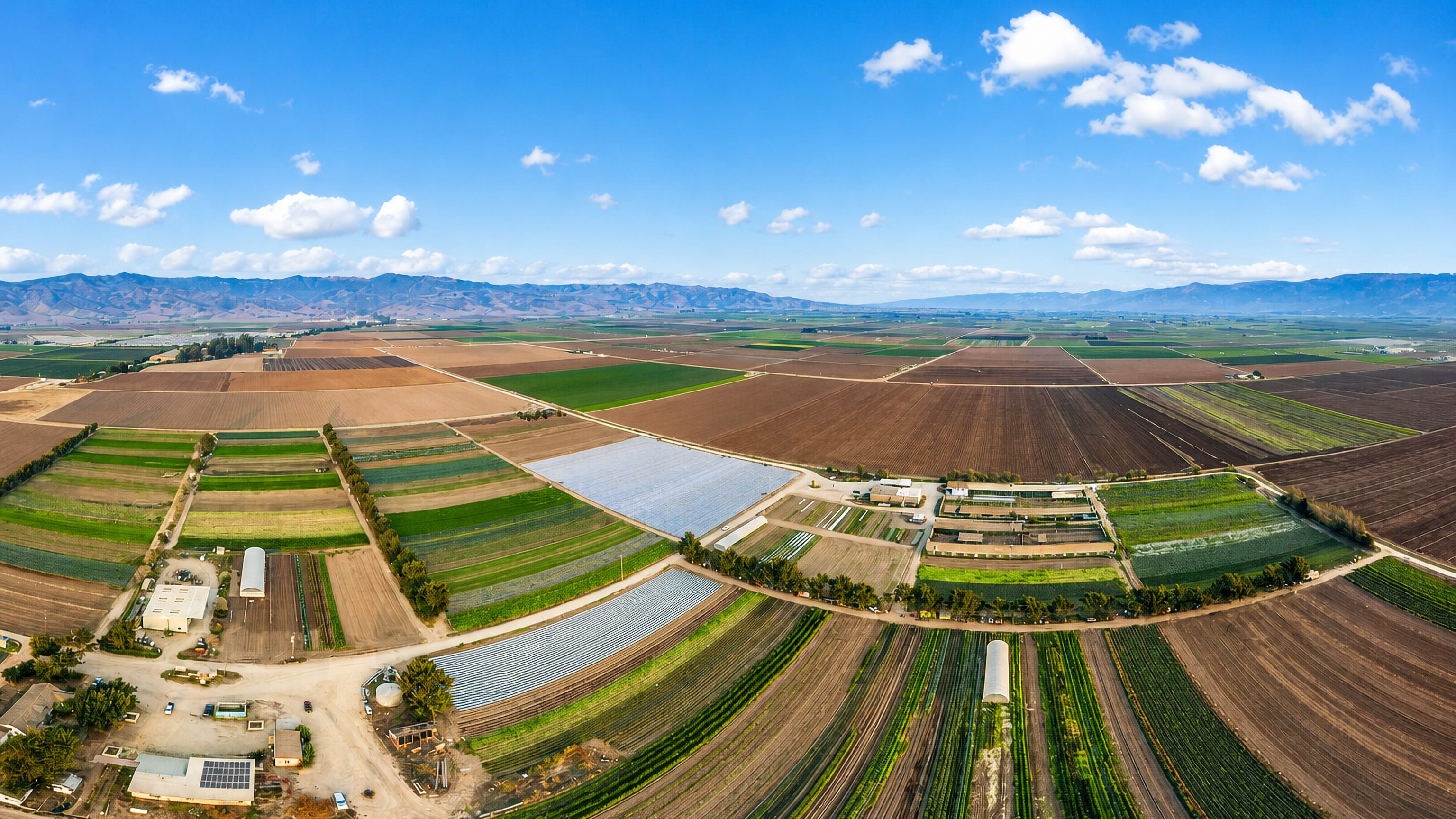 Patchwork lettuce and vegetable fields of the Salinas Valley stretching to the Gabilan Range behind Salinas, California.