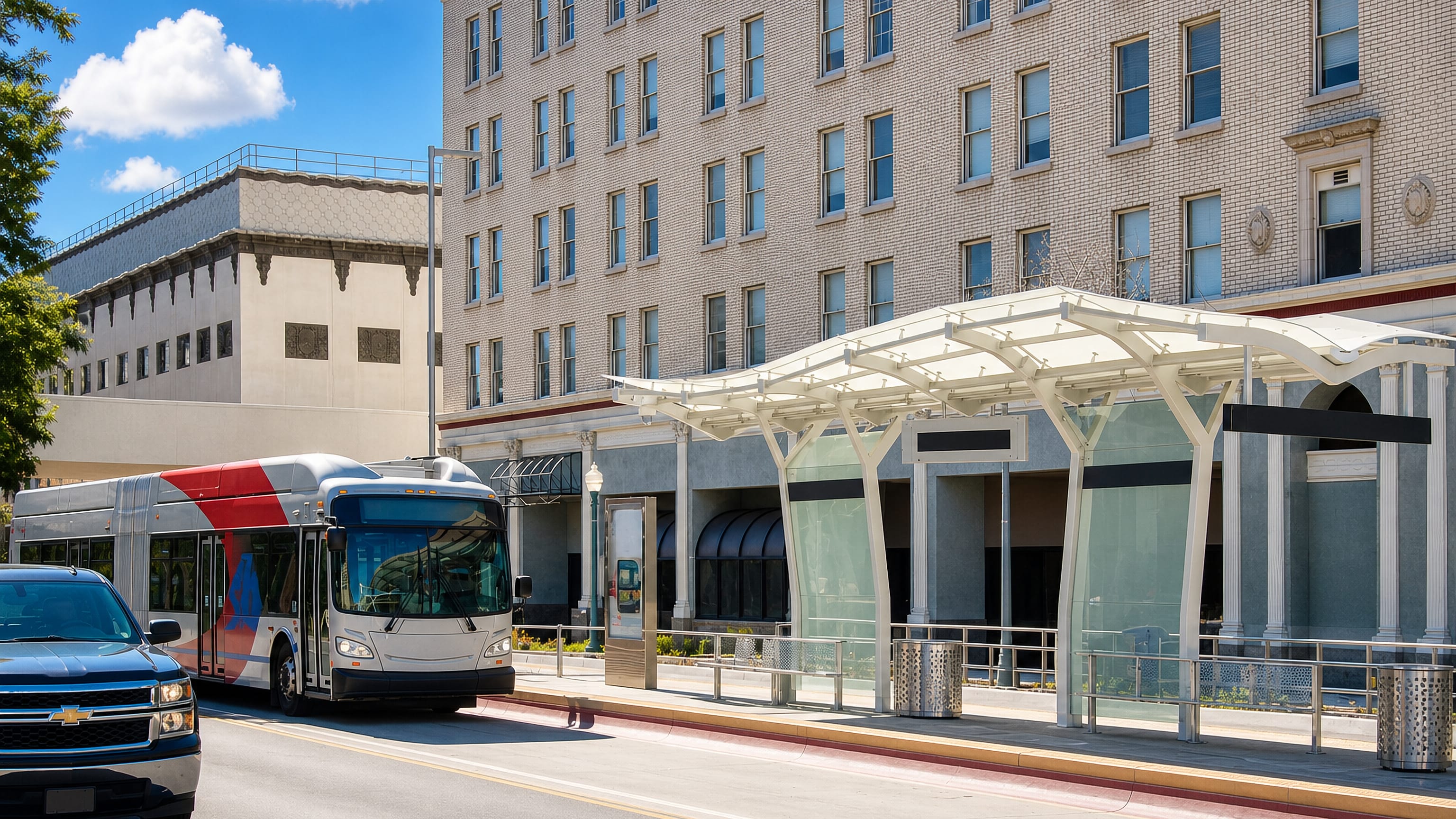 A bus rapid transit stop beside brick downtown buildings on a street in San Bernardino, California.