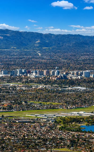 Aerial view of downtown San Jose in the Santa Clara Valley backed by the surrounding hills