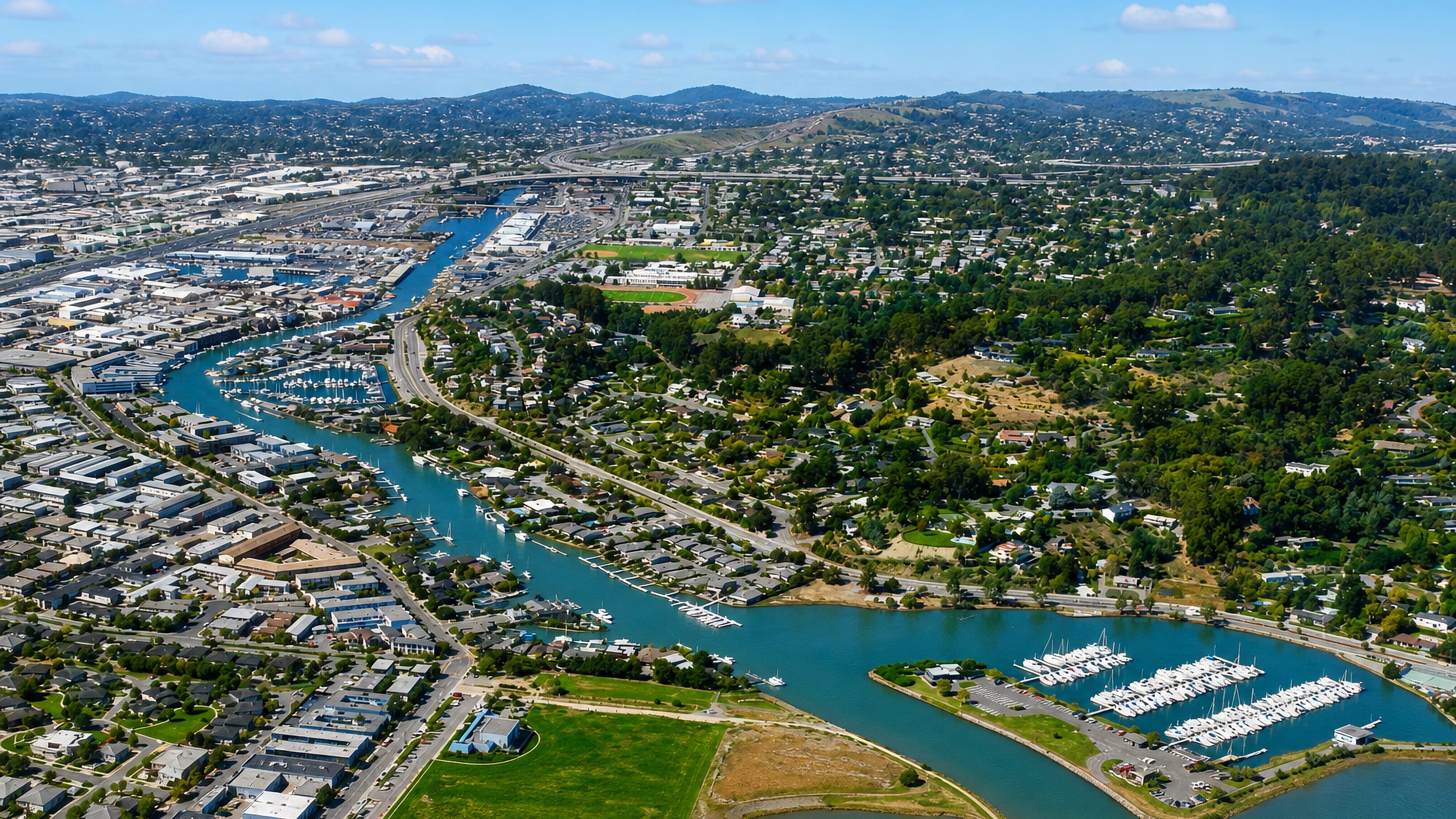 Aerial view of San Rafael, California, its canal and marinas winding between the Marin hills.