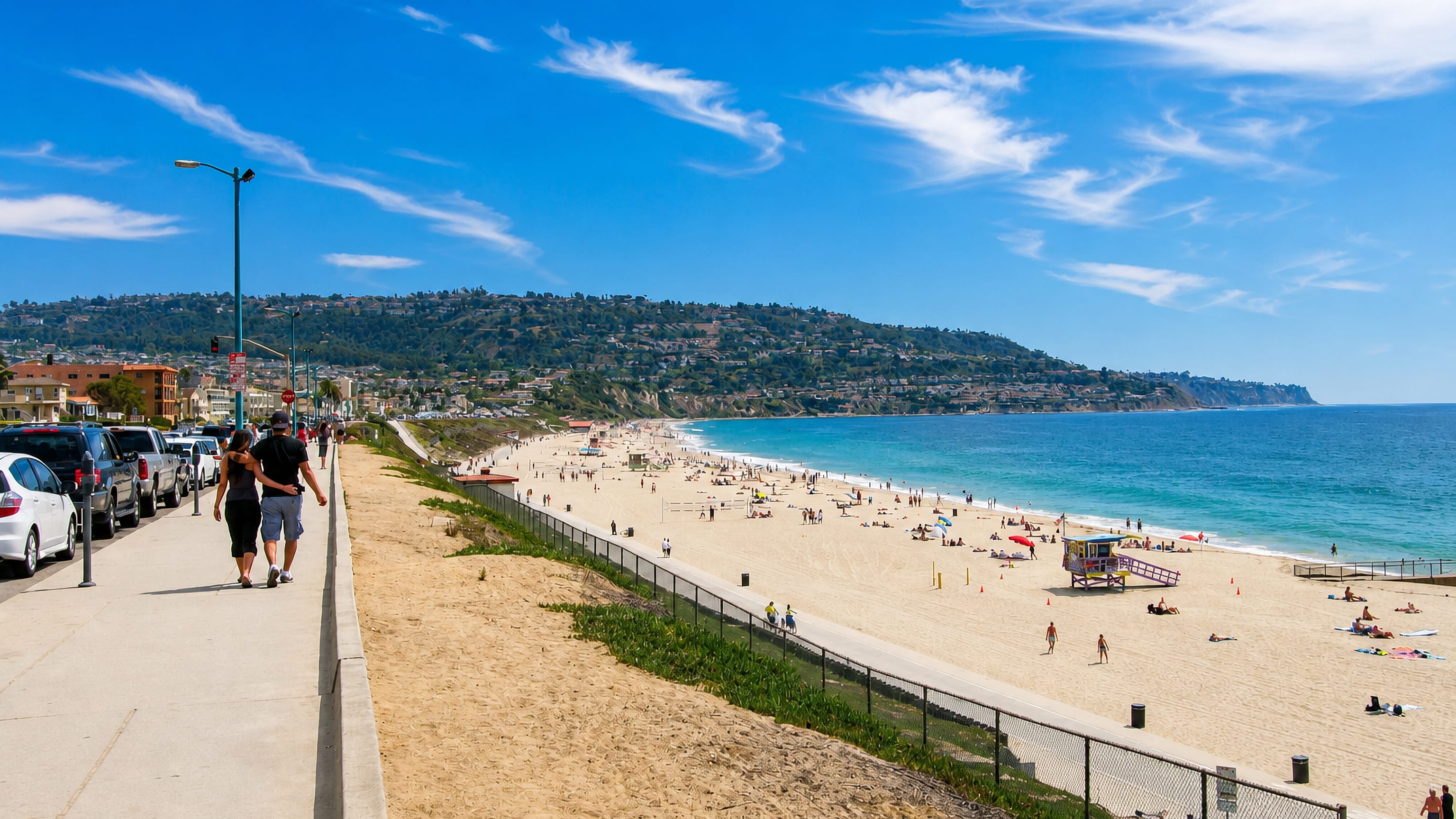 Torrance Beach and its Esplanade walkway in California, with the Palos Verdes hills rising beyond the sand.