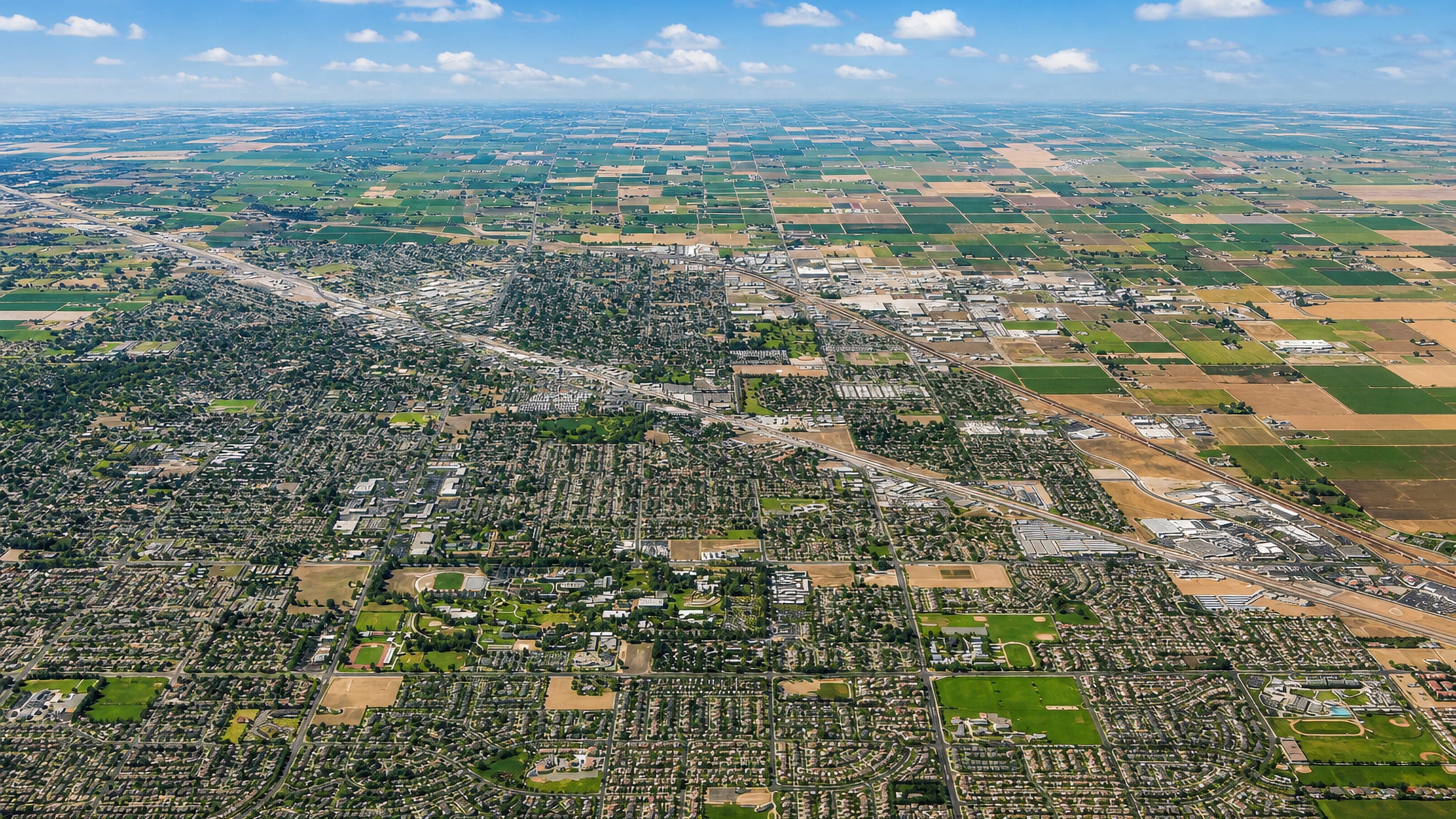 High aerial of Turlock spread across the San Joaquin Valley farm grid in California