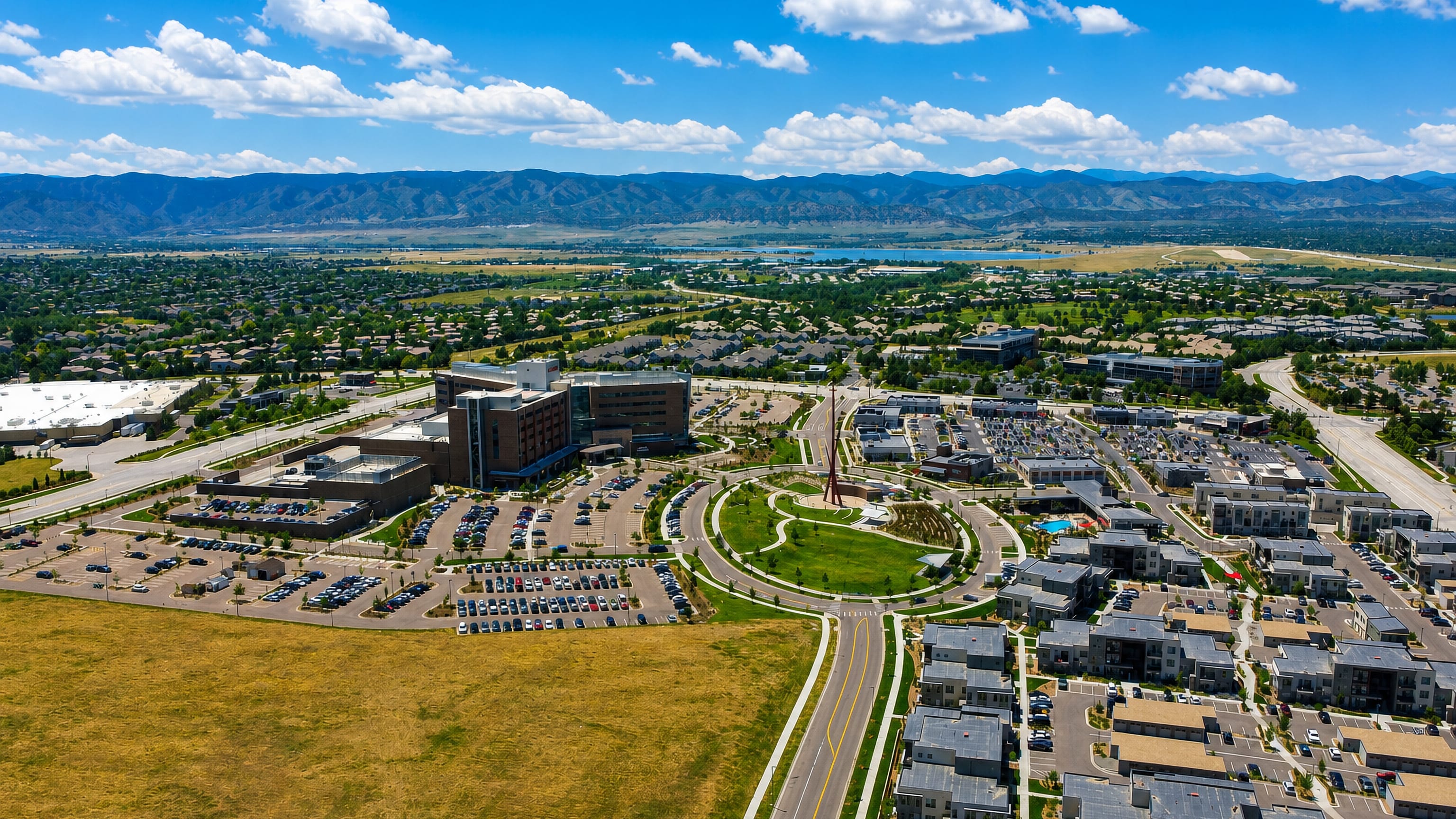 Aerial of Highlands Ranch town centre, hospital and homes with the Colorado Front Range beyond