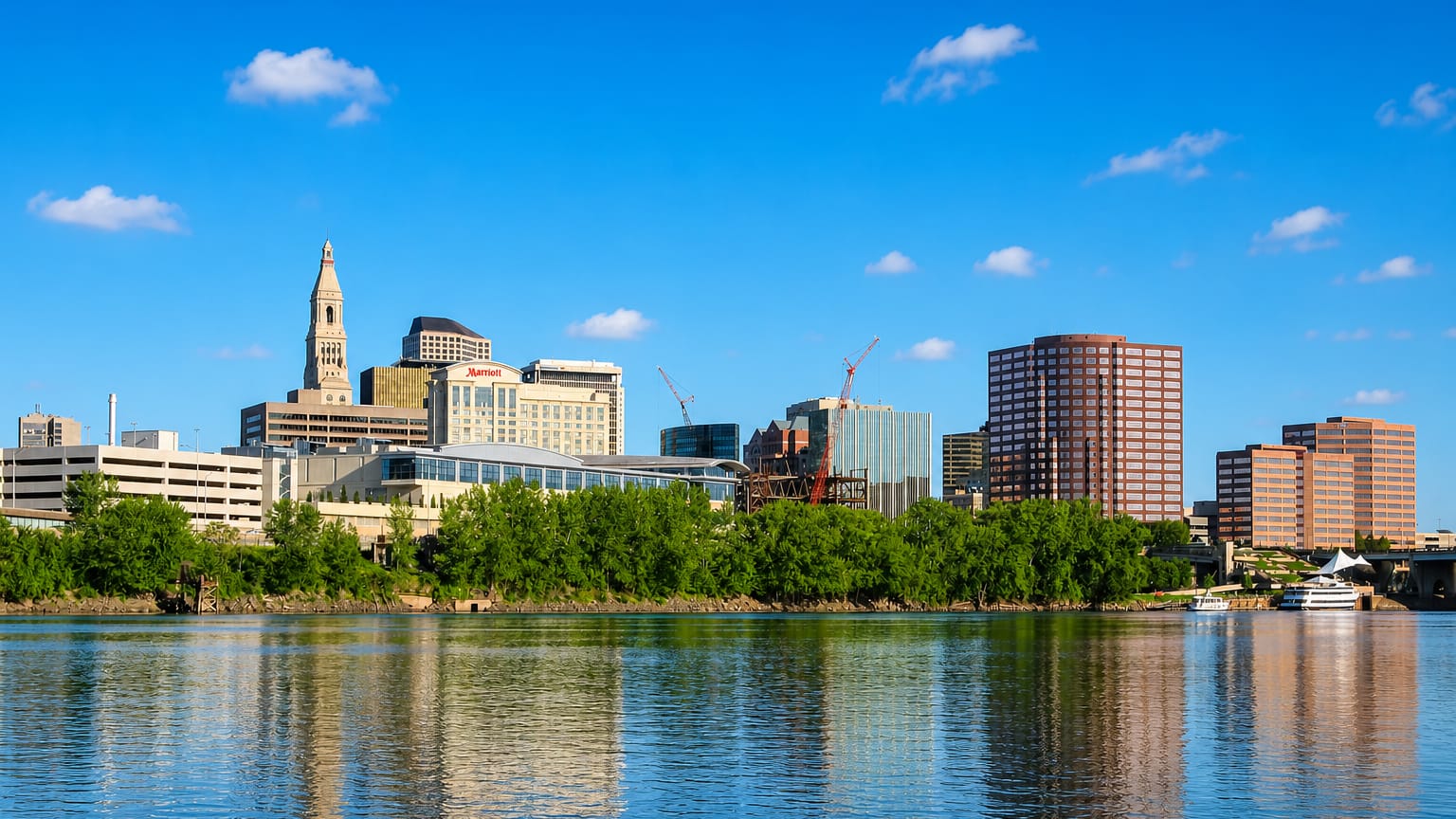 Hartford, Connecticut, skyline with the Travelers Tower and riverfront buildings reflected in the Connecticut River.