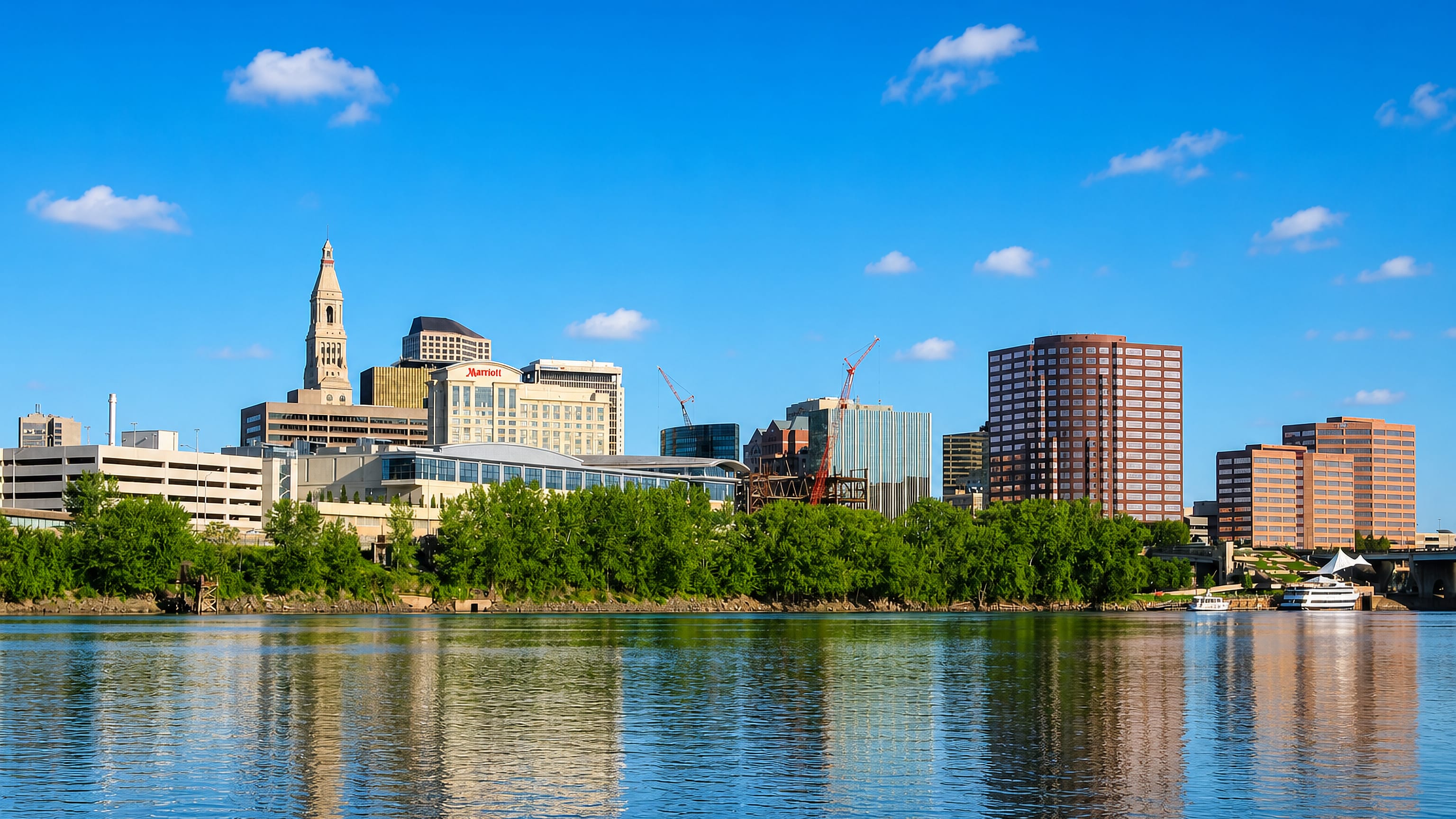 Hartford, Connecticut, skyline with the Travelers Tower and riverfront buildings reflected in the Connecticut River.