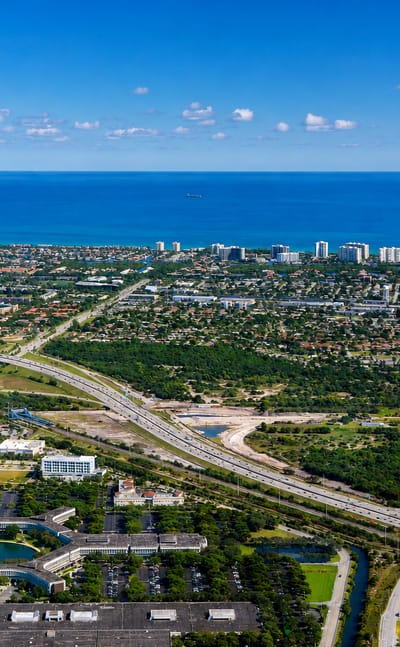 Aerial view of Boca Raton, Florida, with office parks and suburbs stretching to the Atlantic coast.