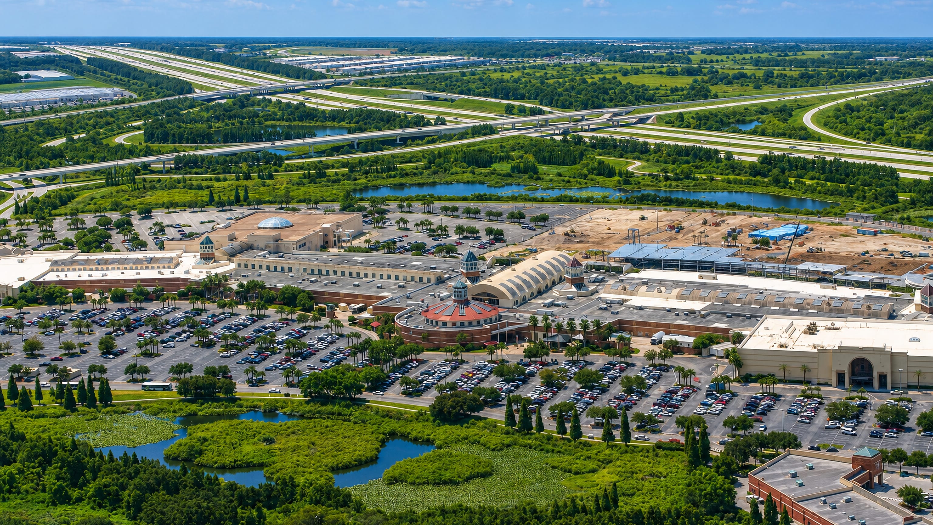 Aerial view of Brandon, Florida, with its shopping mall, wide parking lots, wetland ponds and highway interchange.