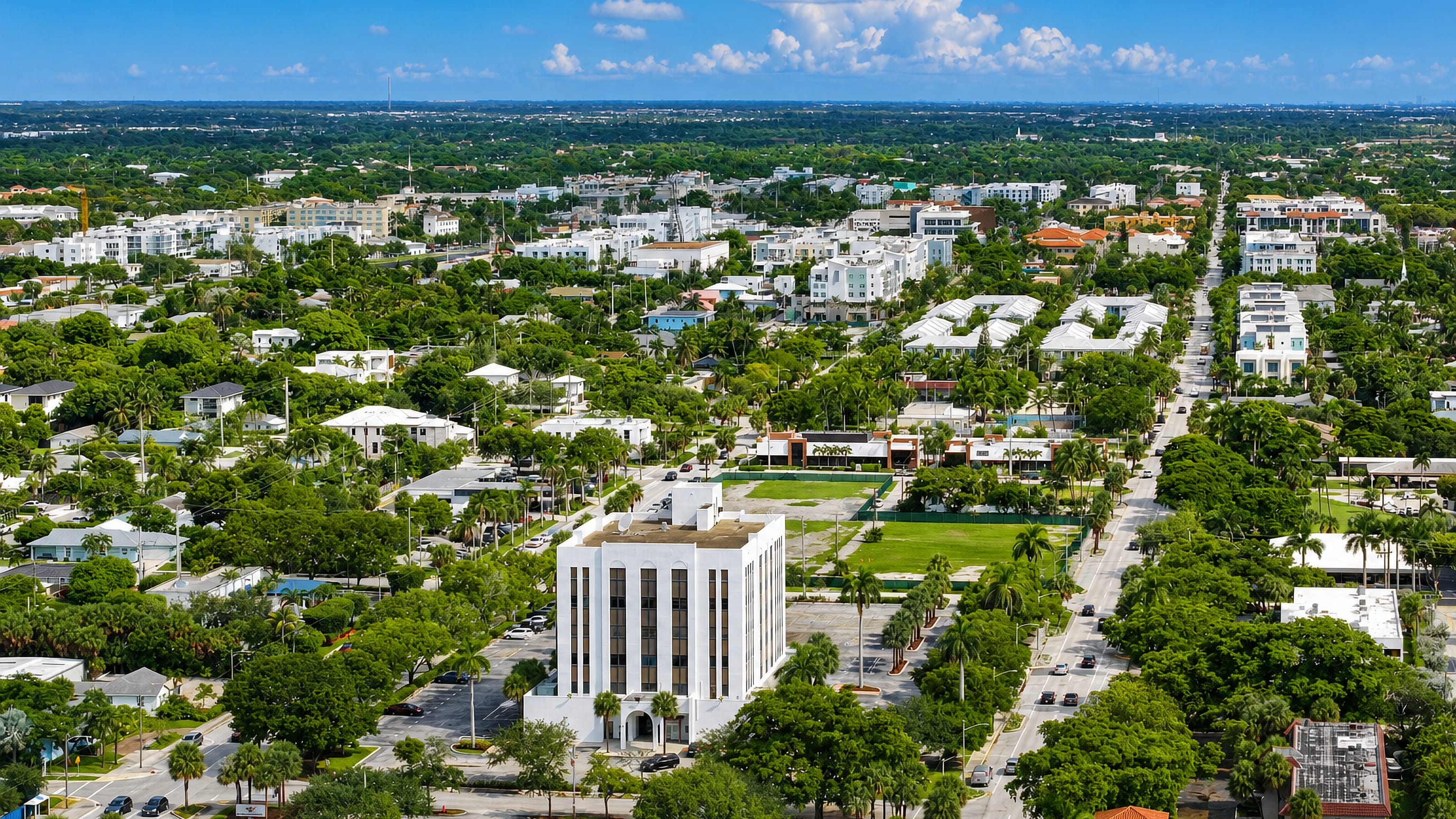 Aerial view of Delray Beach, Florida, with palm-lined avenues, low white buildings and dense greenery
