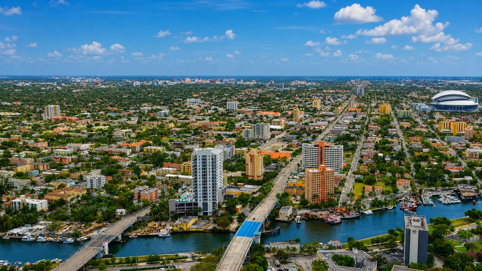 Aerial view of Little Havana in Miami along the Miami River, with mid-rise towers and the ballpark