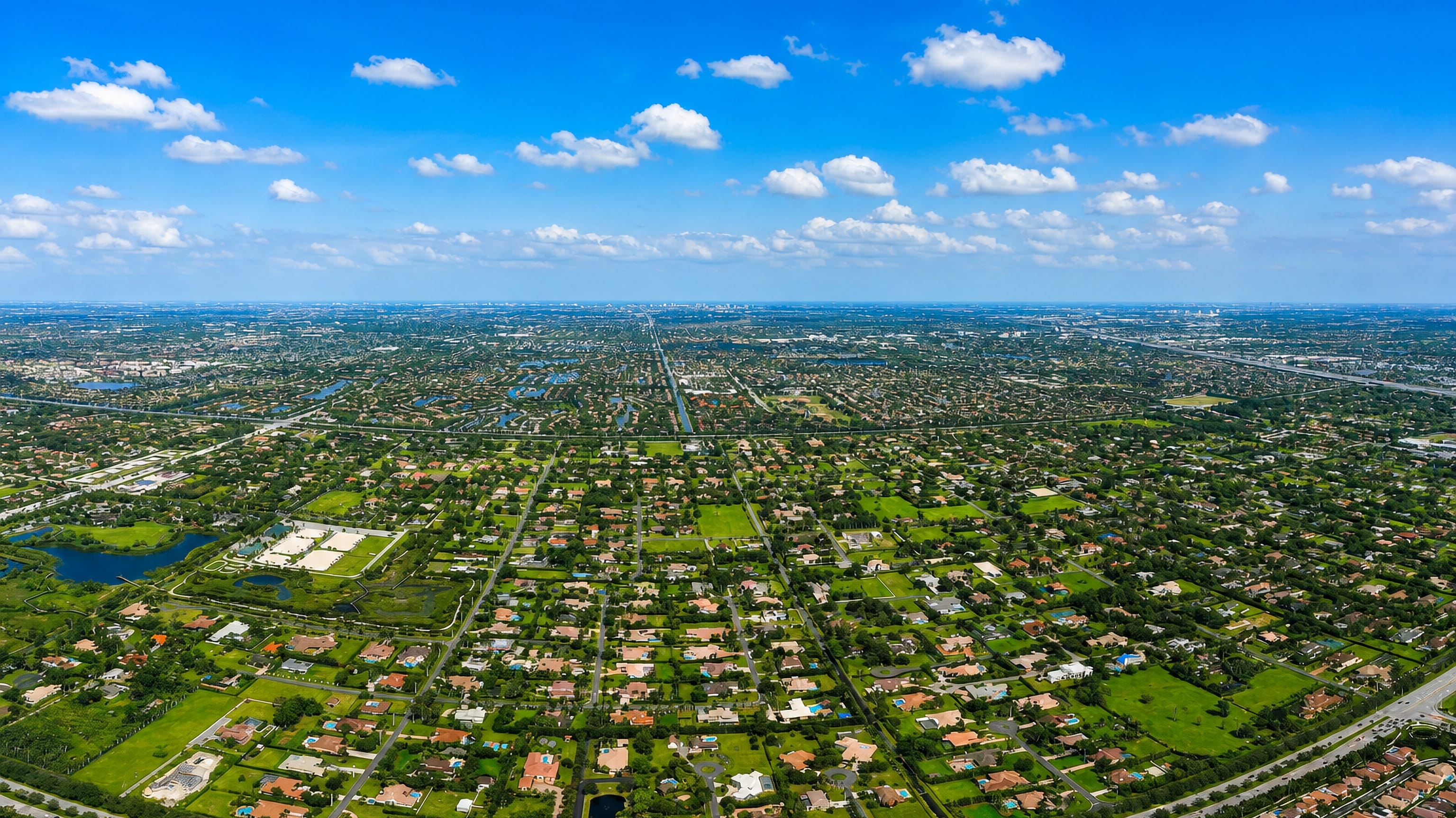 Plantation's canal-laced Florida suburbs stretch flat toward the distant Fort Lauderdale skyline.