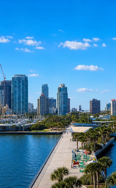 Downtown St. Petersburg, Florida skyline behind the waterfront pier over Tampa Bay on a sunny day.