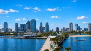 Downtown St. Petersburg, Florida skyline behind the waterfront pier over Tampa Bay on a sunny day.