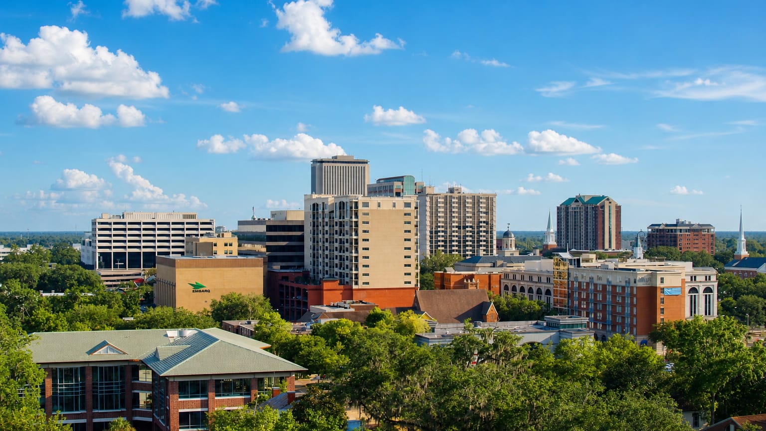 Downtown Tallahassee's mid-rise towers and church spires rise above moss-draped live oaks.