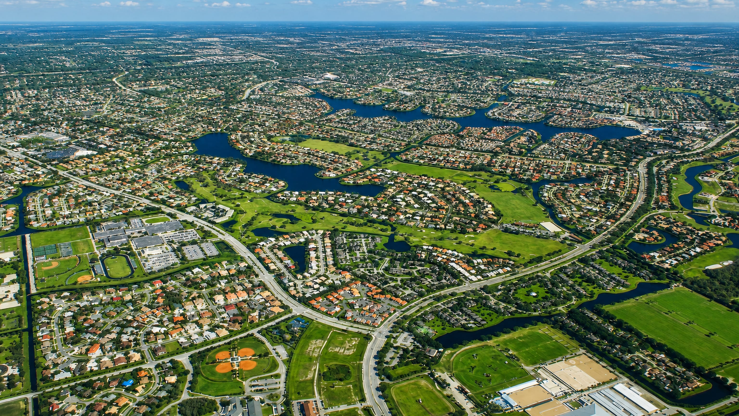 Aerial view of Wellington, Florida, its lakes, golf greens and equestrian grounds threaded through suburbs.