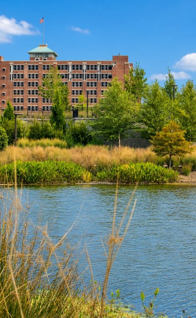 Historic Fourth Ward Park pond with Ponce City Market rising behind in Atlanta's Old Fourth Ward