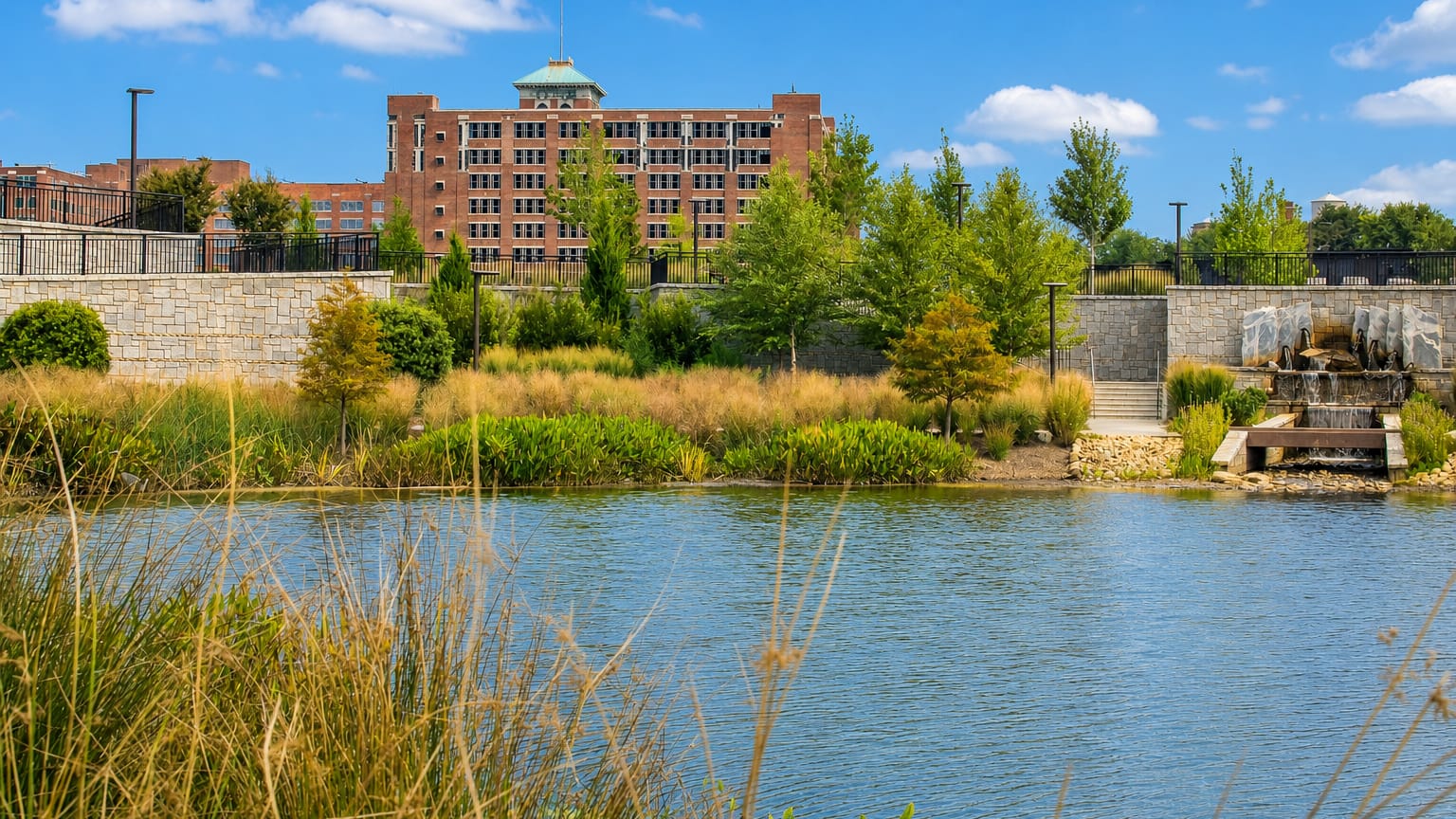 Historic Fourth Ward Park pond with Ponce City Market rising behind in Atlanta's Old Fourth Ward