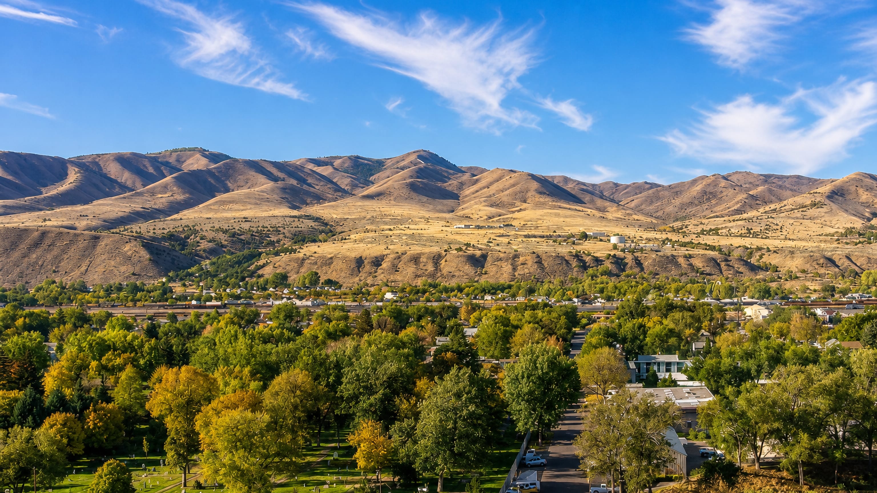 Pocatello, Idaho, tree-lined streets and rail yards below the dry golden foothills of the Bannock Range.