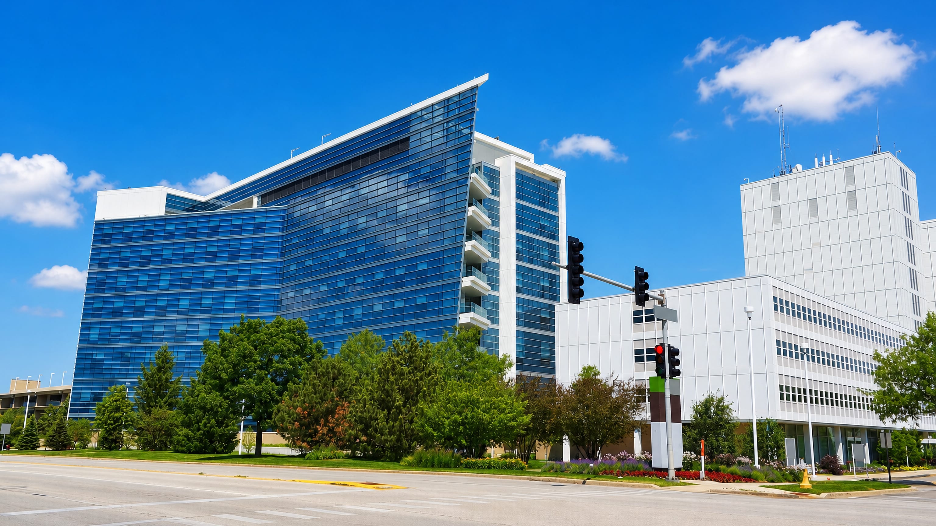 Blue glass office tower and low-rise offices at a street corner in Arlington Heights, Illinois.