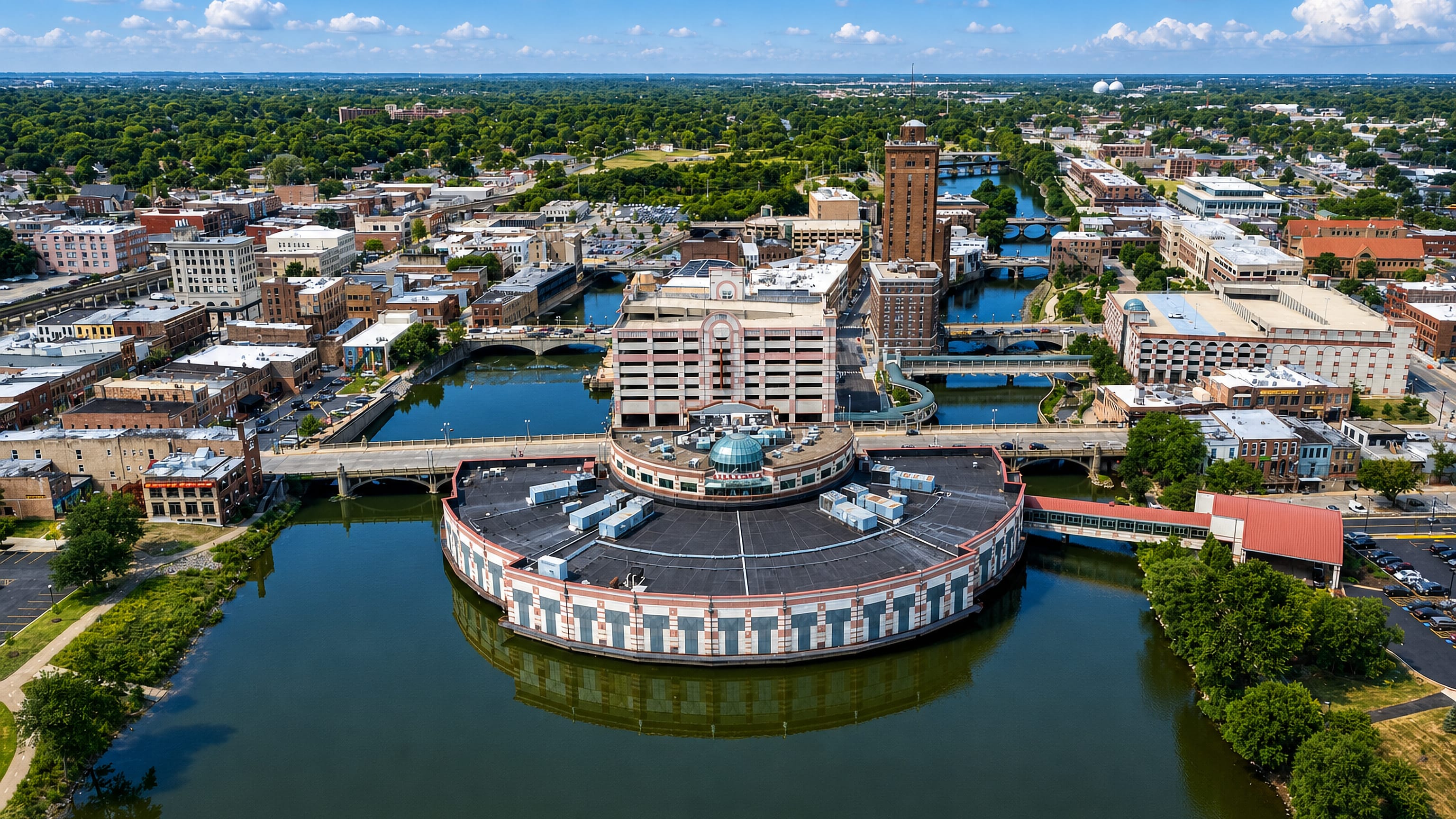 Downtown Aurora, Illinois from above, the Fox River wrapping the island casino with Leland Tower behind.