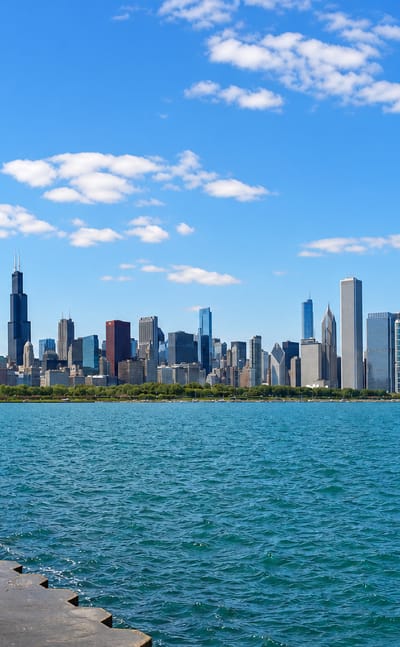 Chicago's downtown skyline seen across Lake Michigan from the lakefront, with Willis Tower and the Museum Campus.