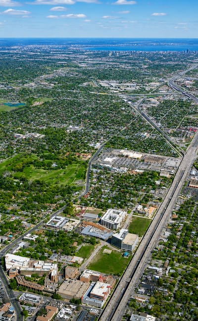 Aerial view over green residential Chicago with the distant downtown skyline along Lake Michigan