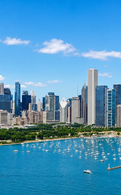 Downtown Chicago skyline with the Willis Tower rising above the lakefront and a harbor full of sailboats on Lake Michigan