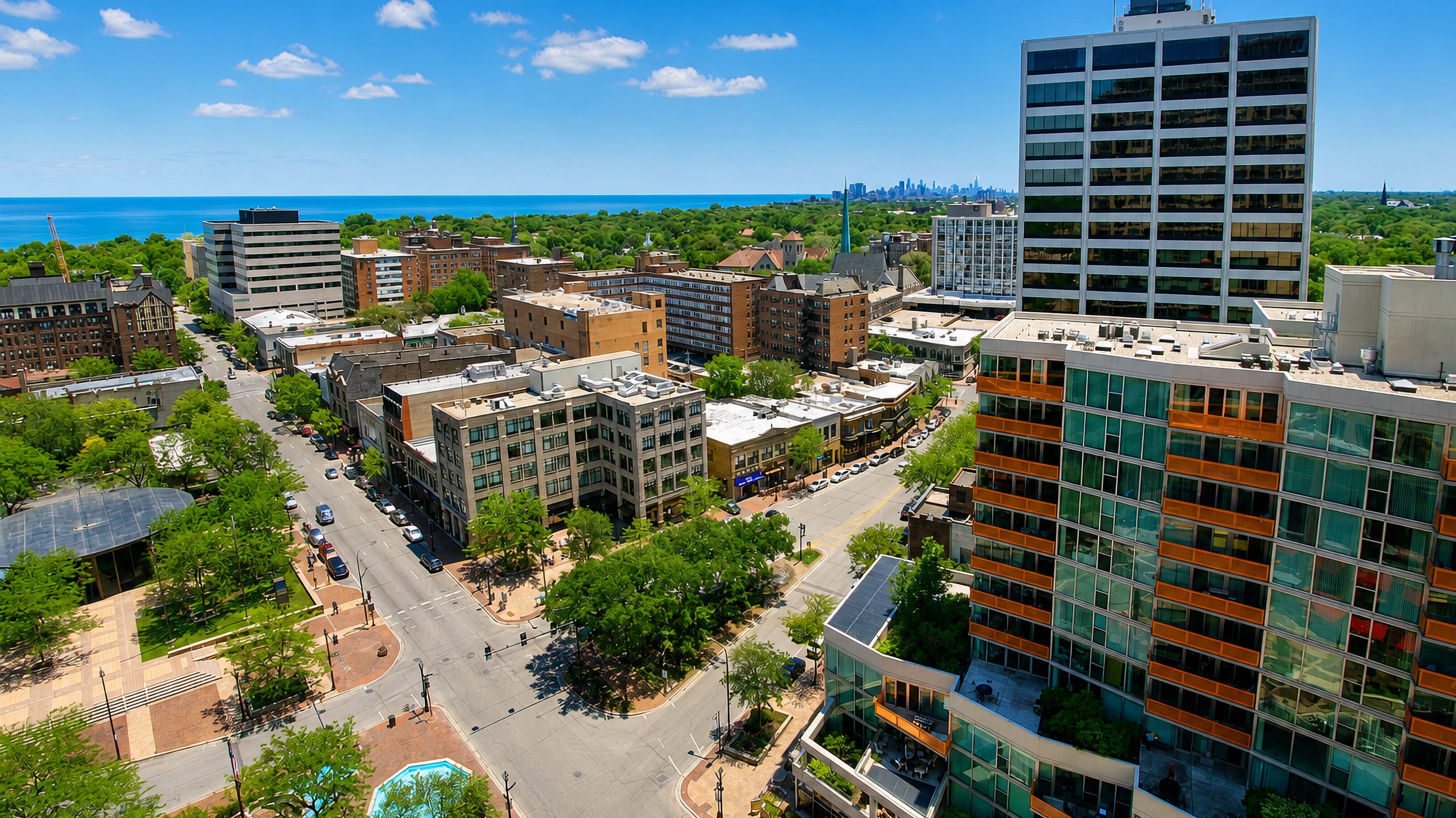 Downtown Evanston, Illinois, seen from above with Lake Michigan and the distant Chicago skyline on the horizon.