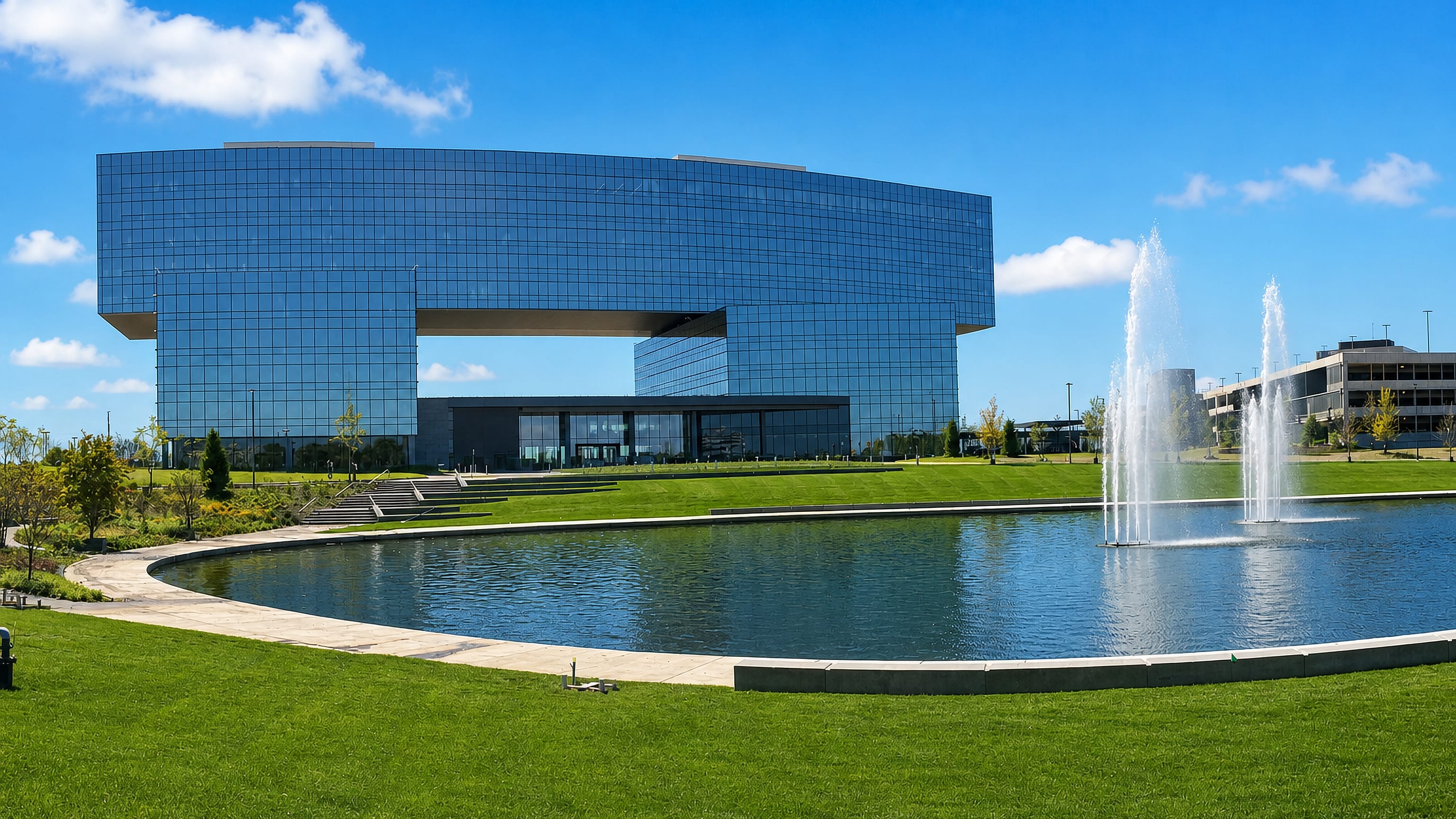 Schaumburg, Illinois' cantilevered glass office tower mirrored in a landscaped reflecting pool.