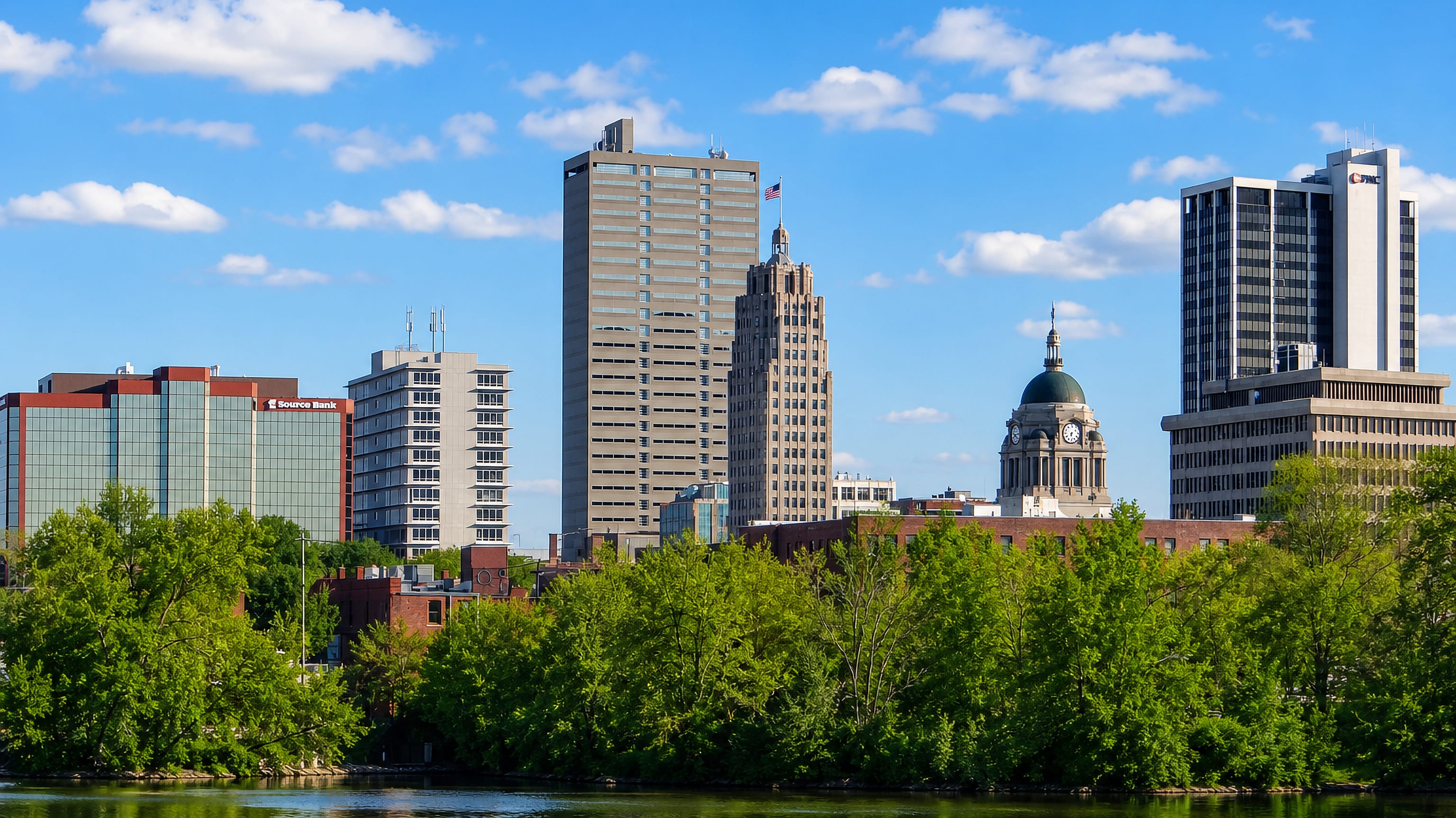 Fort Wayne, Indiana's downtown skyline with the Allen County Courthouse dome and art deco tower above the St. Marys River.