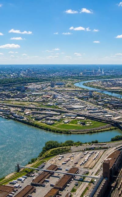 Aerial over the Kansas River confluence, rail yards and the distant downtown skyline of Kansas City, Kansas.