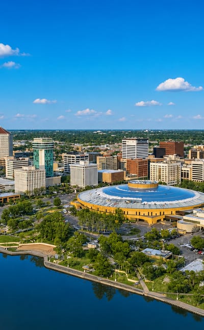 Aerial view of downtown Wichita with the Century II domed complex beside the Arkansas River.