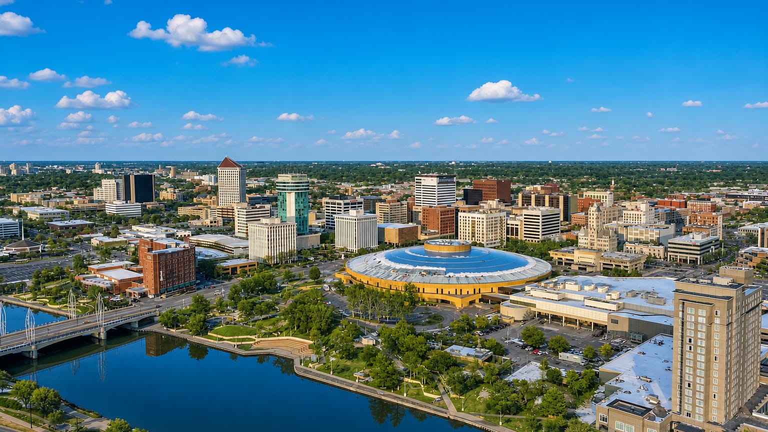 Aerial view of downtown Wichita with the Century II domed complex beside the Arkansas River.