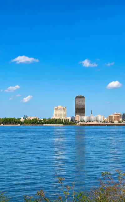 Baton Rouge skyline on the Mississippi River anchored by the tall art-deco Louisiana State Capitol tower.