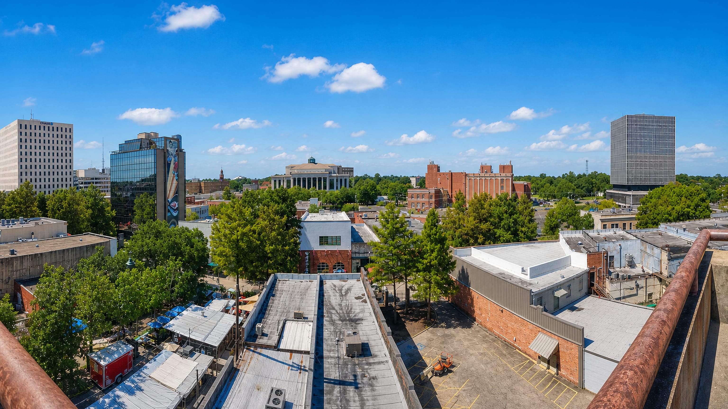 Rooftop view over downtown Lafayette, Louisiana, with its courthouse tower, glass office block and domed civic building.