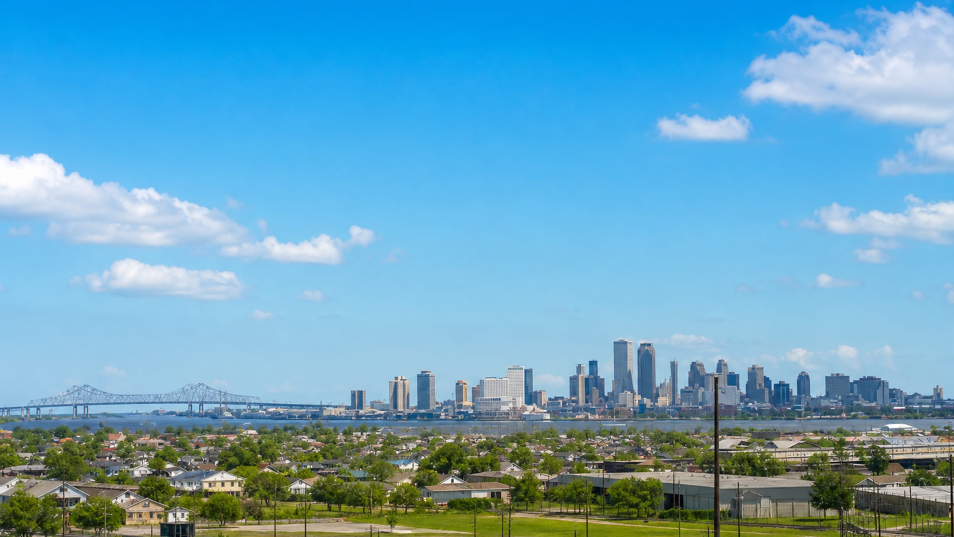 The Ninth Ward of New Orleans above the Mississippi, with the downtown skyline and river bridge