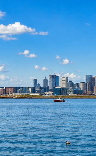 The Boston skyline with the Prudential and Hancock towers rising across the harbor from South Boston.
