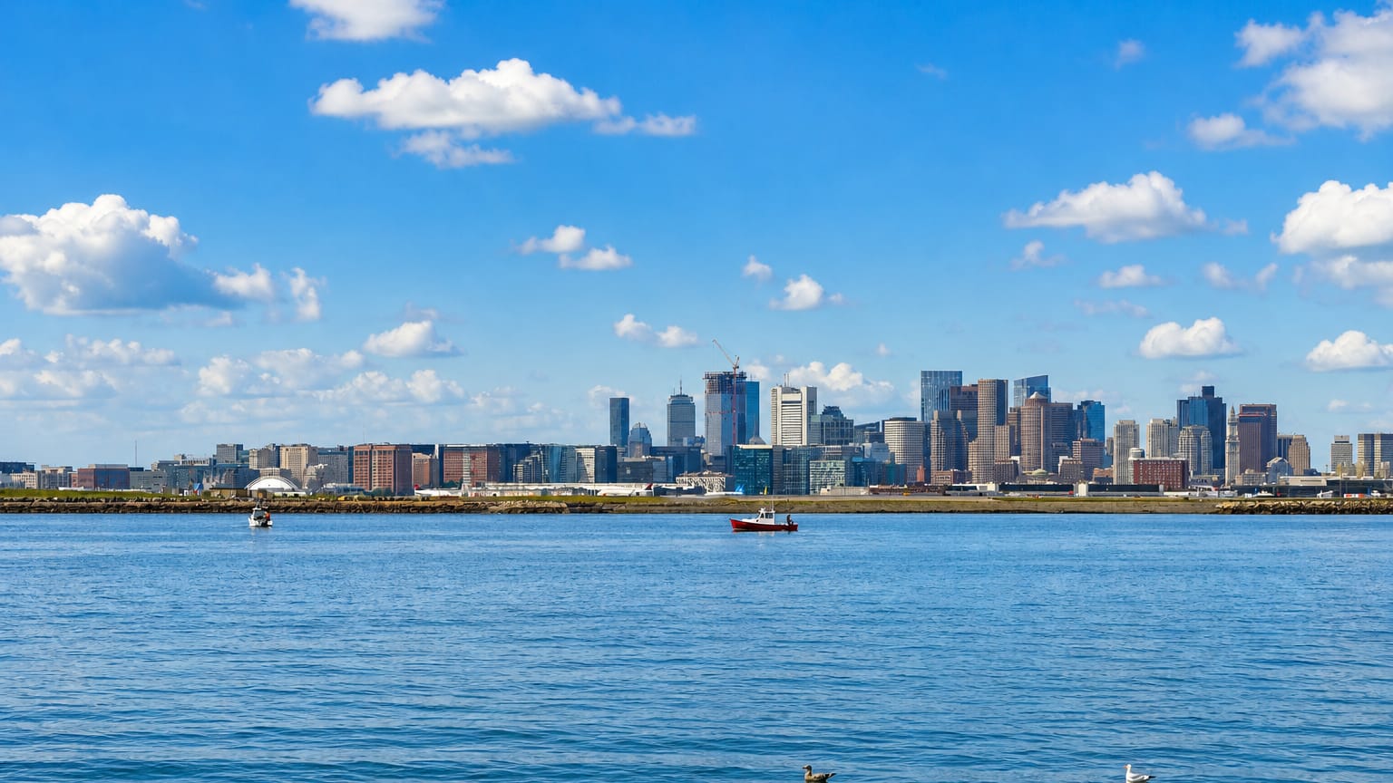 The Boston skyline with the Prudential and Hancock towers rising across the harbor from South Boston.