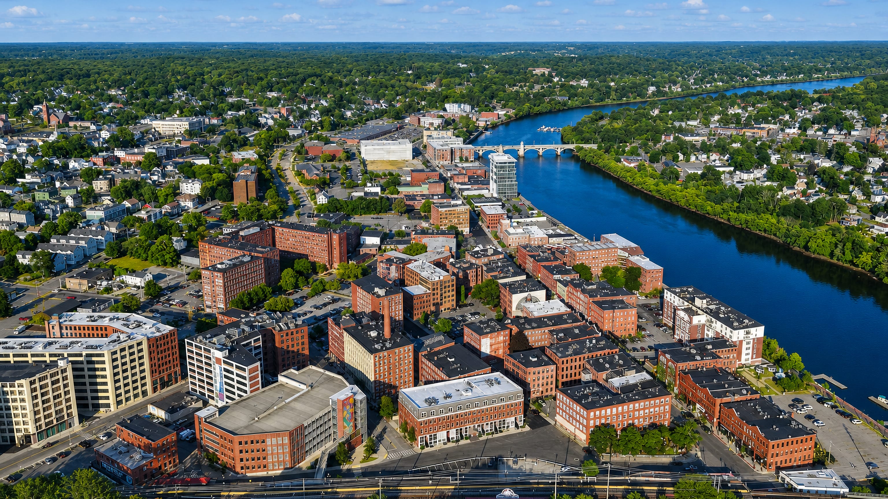 Haverhill, Massachusetts, from above: red-brick mill blocks lining the Merrimack River and its bridge.