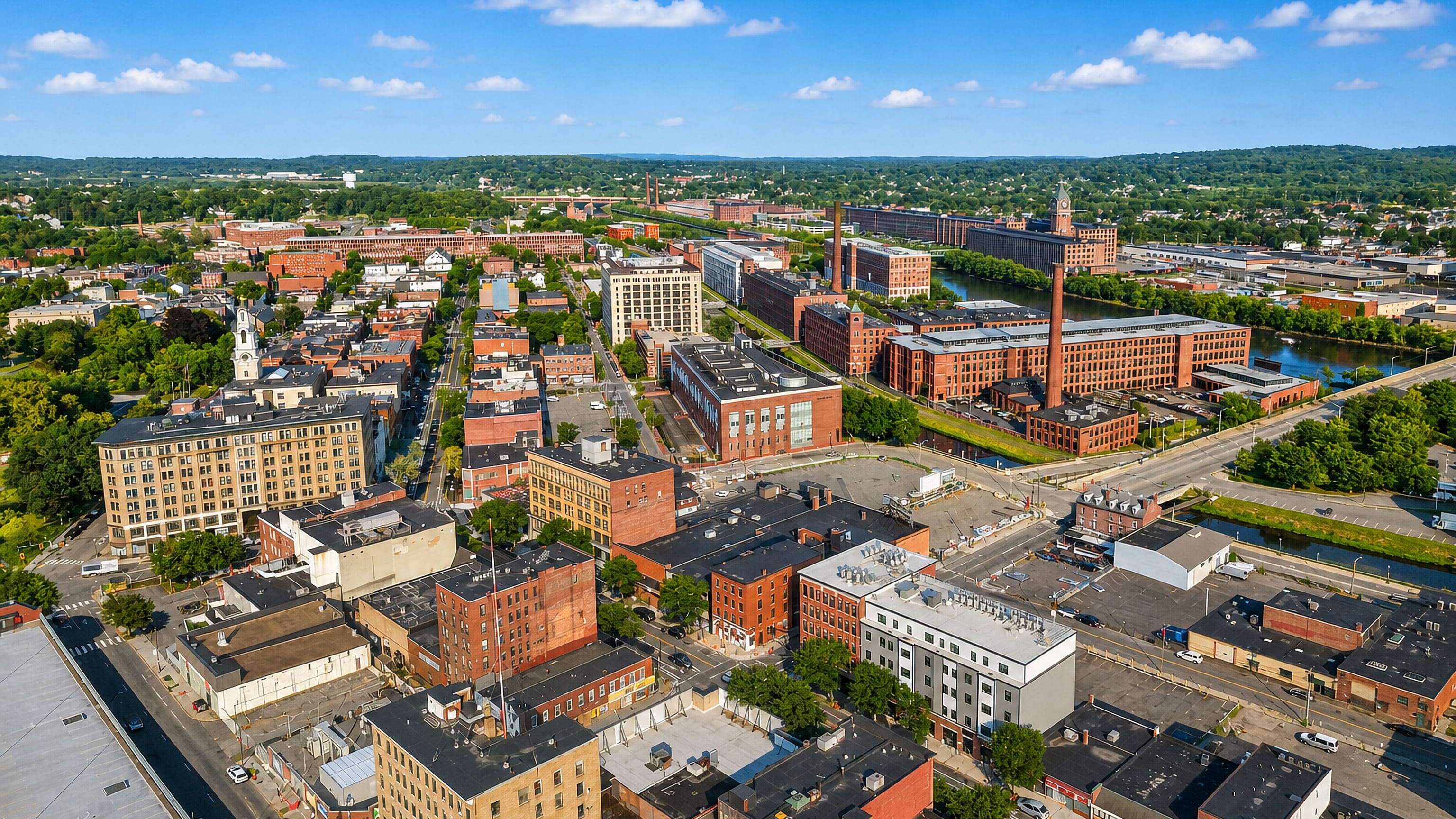 Aerial view of Lawrence, Massachusetts, with red-brick mills, canals and the Ayer Mill clock tower.