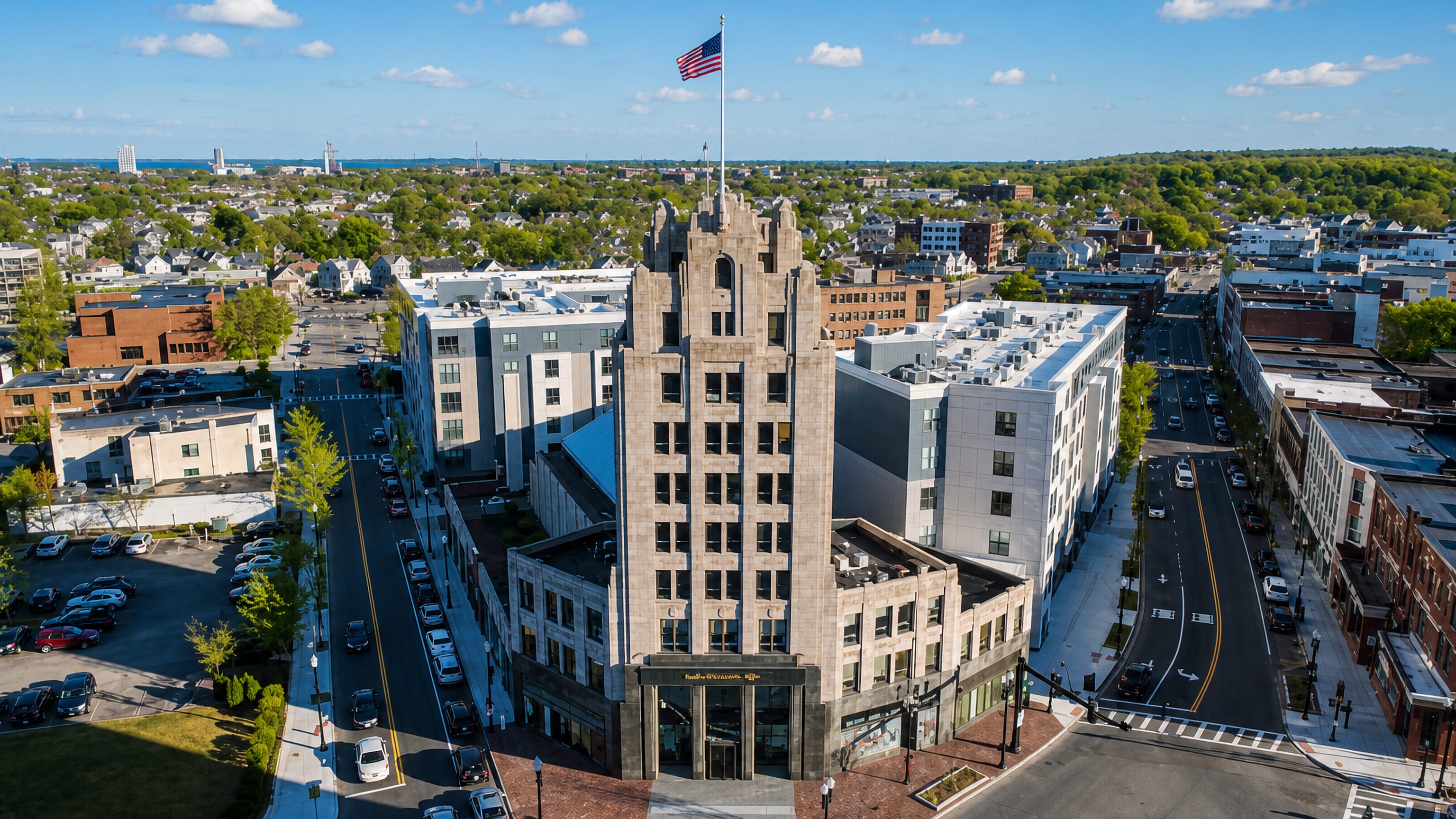 Aerial view of Quincy Center, Massachusetts, with the art deco Granite Trust Building tower and the bay beyond.