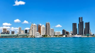 Detroit's downtown skyline across the Detroit River, anchored by the GM Renaissance Center towers.