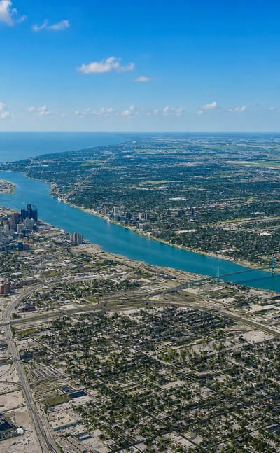 Aerial view over the Detroit River toward downtown Detroit's skyline near the Mexicantown district