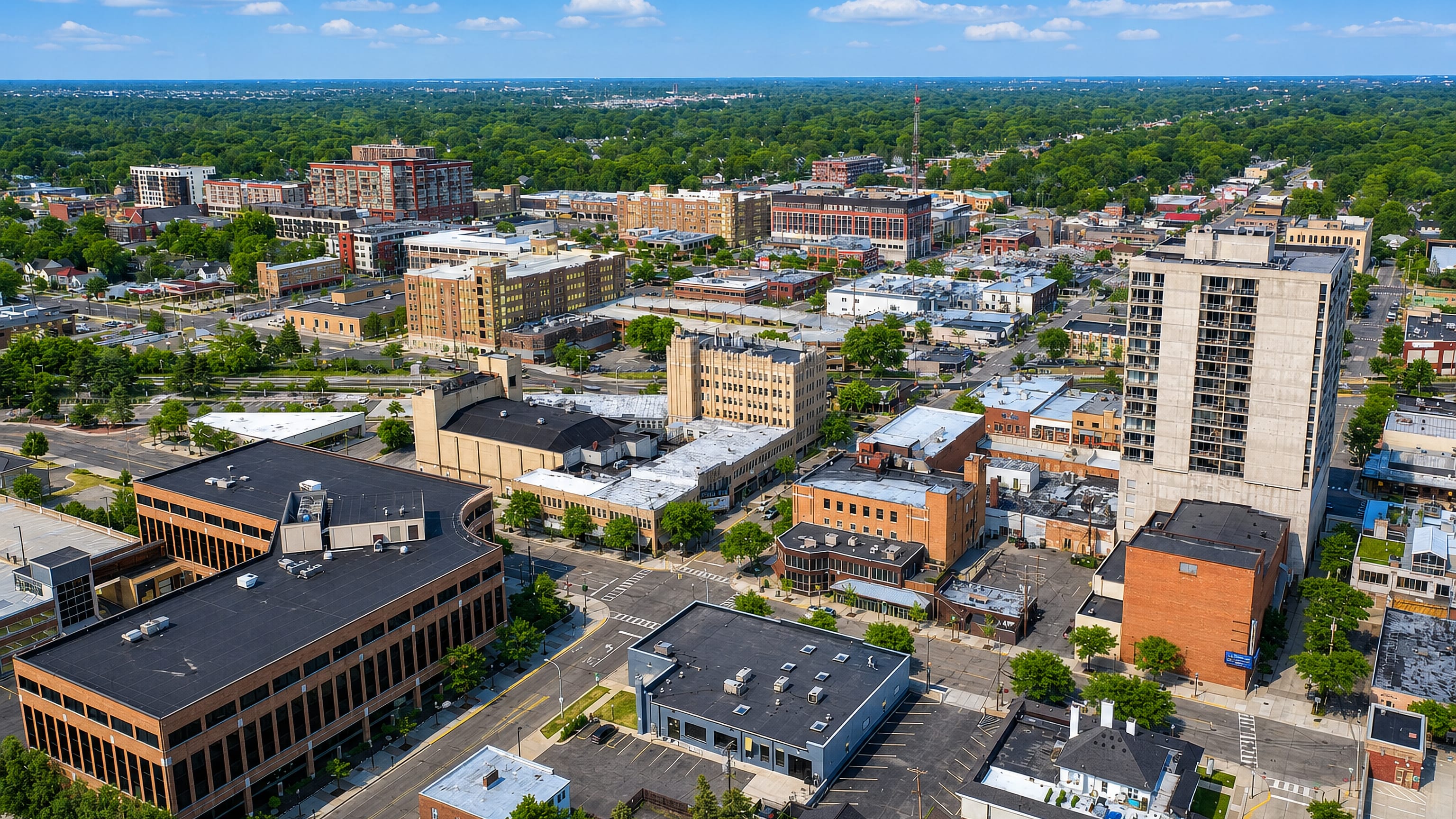 Downtown Royal Oak, Michigan, from the air, with brick storefront blocks and a lone high-rise among leafy streets
